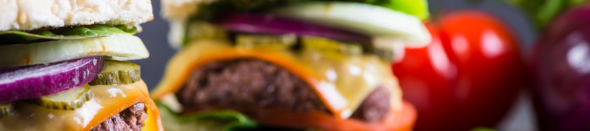 Homemade burger with vegetables on wooden table