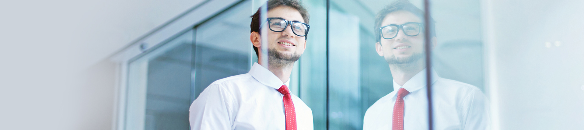 Man with glasses looking through a window