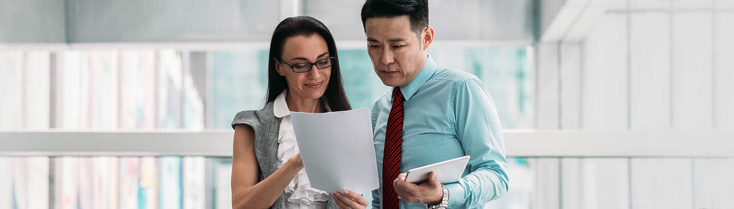 Two colleagues looking at a document