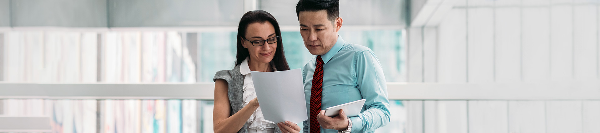 Two colleagues looking at a document