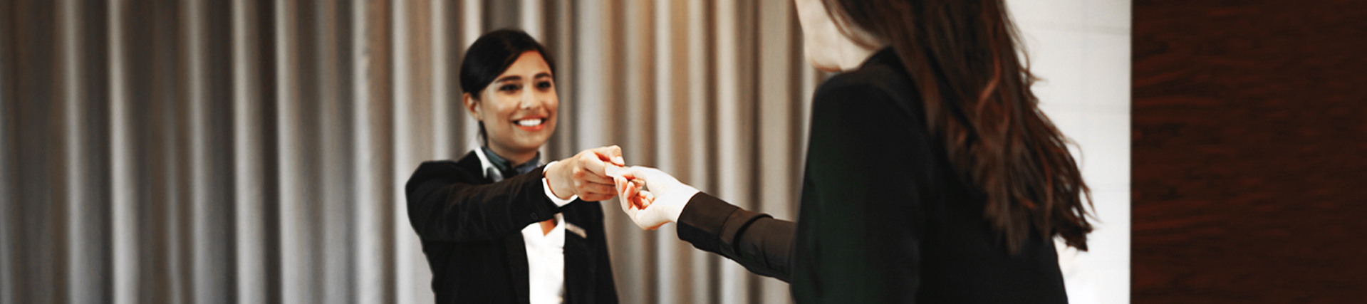 A woman is giving something to another