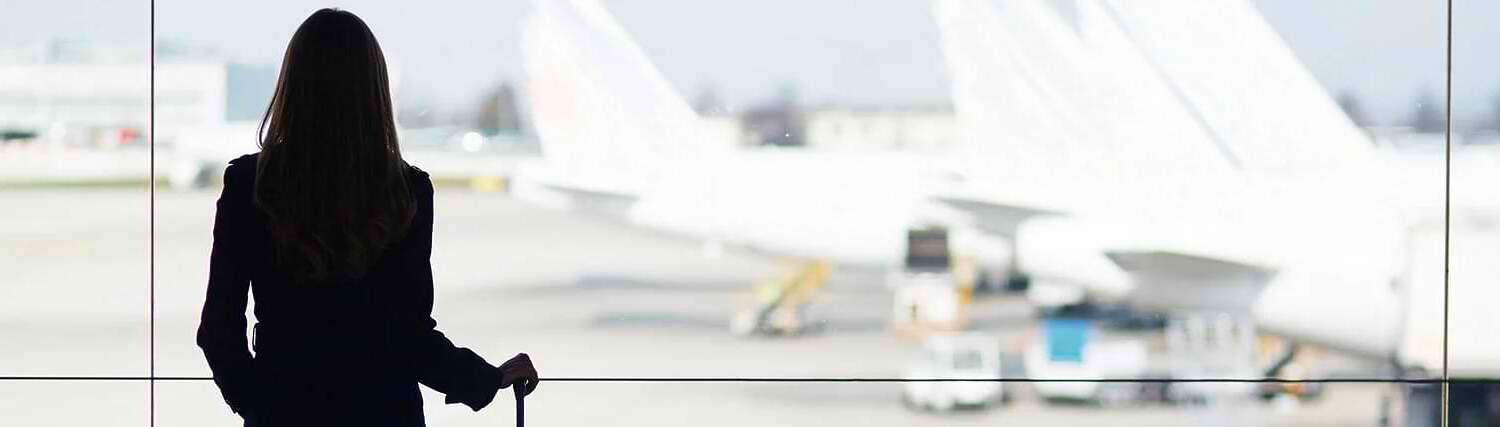 Woman in airport watching planes