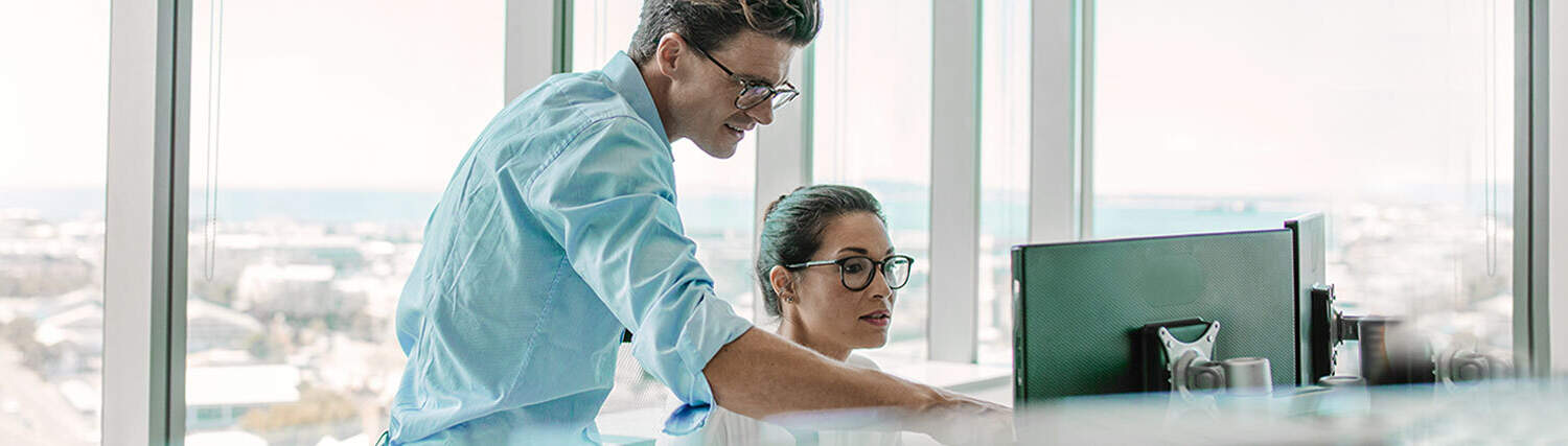 Two people in front of a computer screen