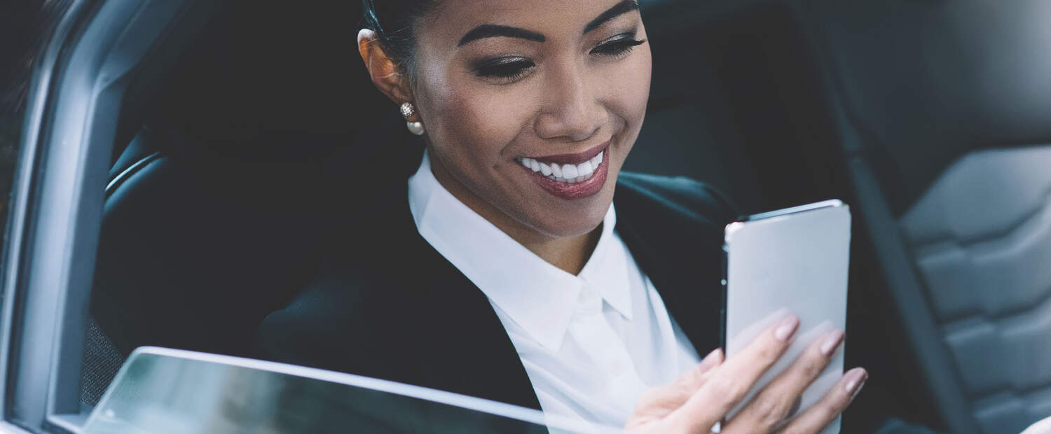 Woman in a car checking her phone