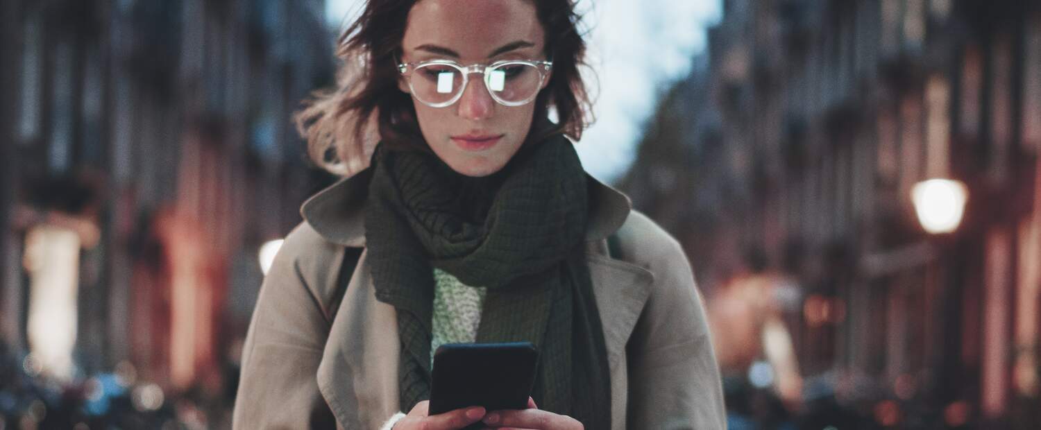 Woman working on her phone in a street