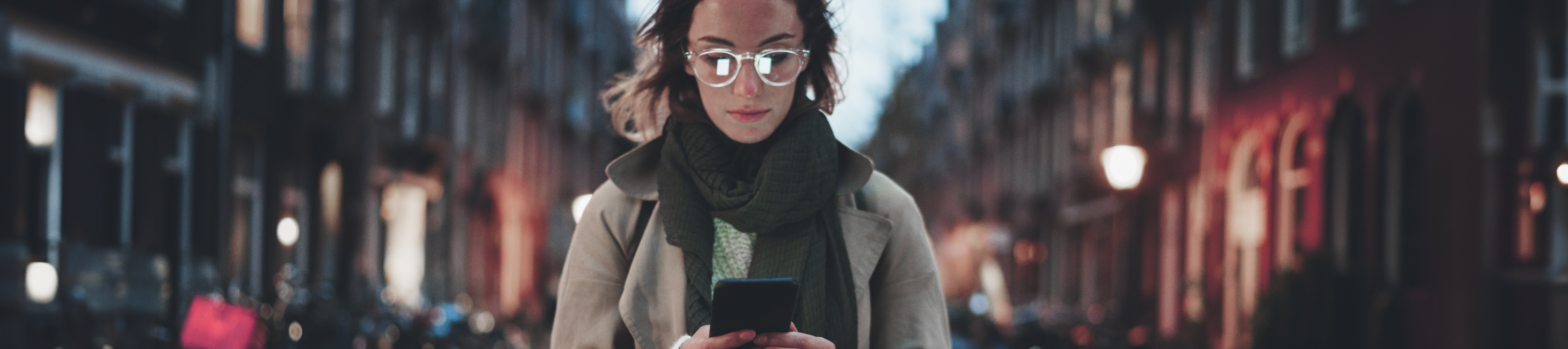 Woman working on her phone in a street