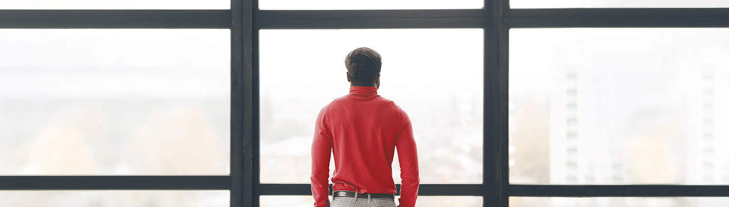 Man looking through a window