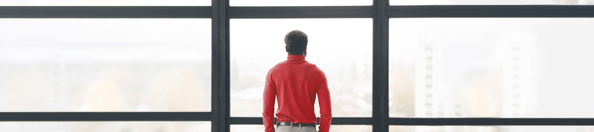Man looking through a window