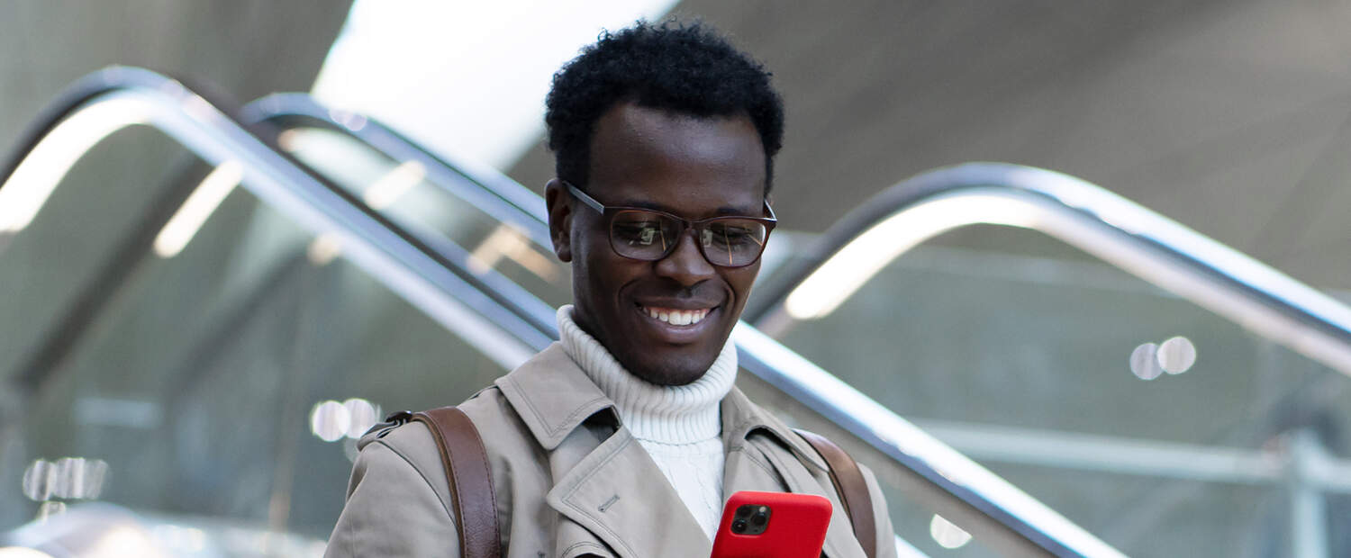 Man watching his phone in the stairs