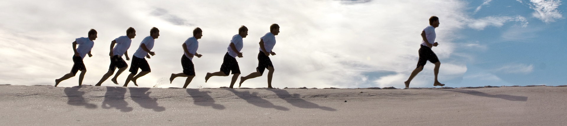 People running on a sand dune