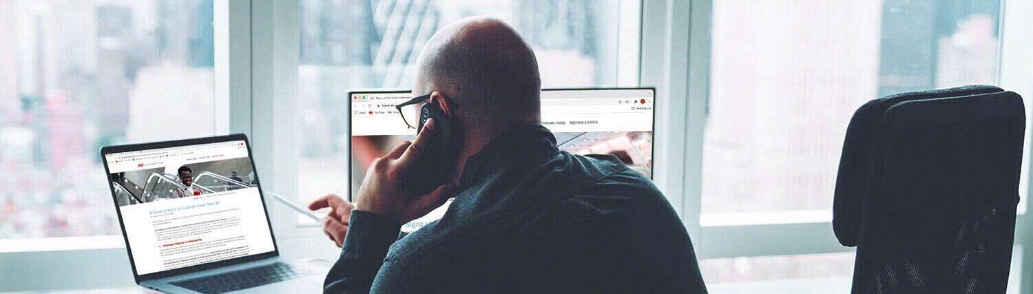 Man on the phone in front of a computer