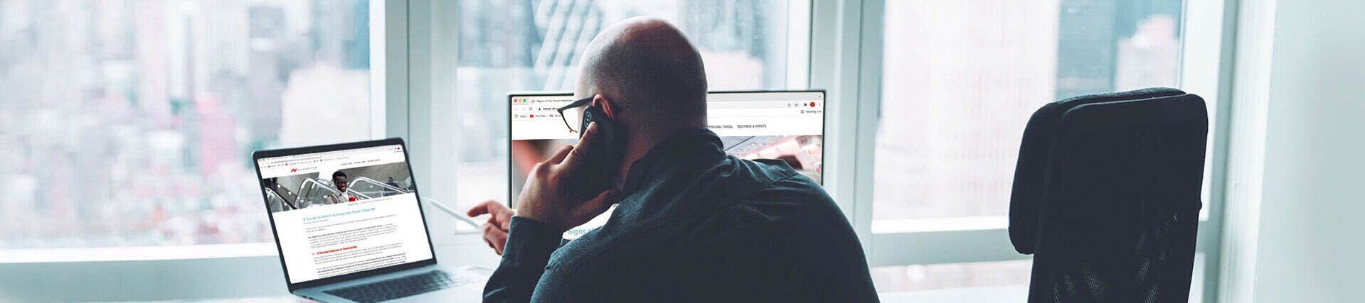 Man on the phone in front of a computer