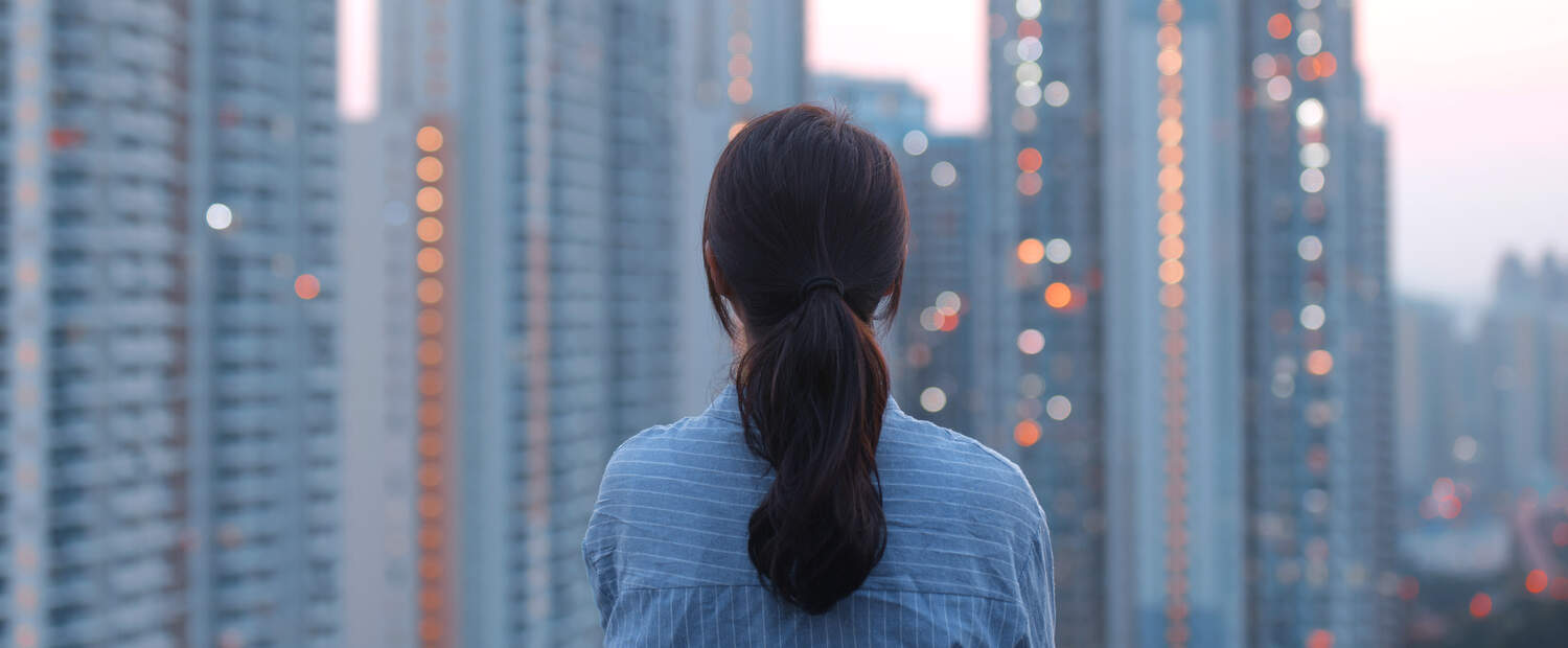 Woman in front of a city looking at the skyline