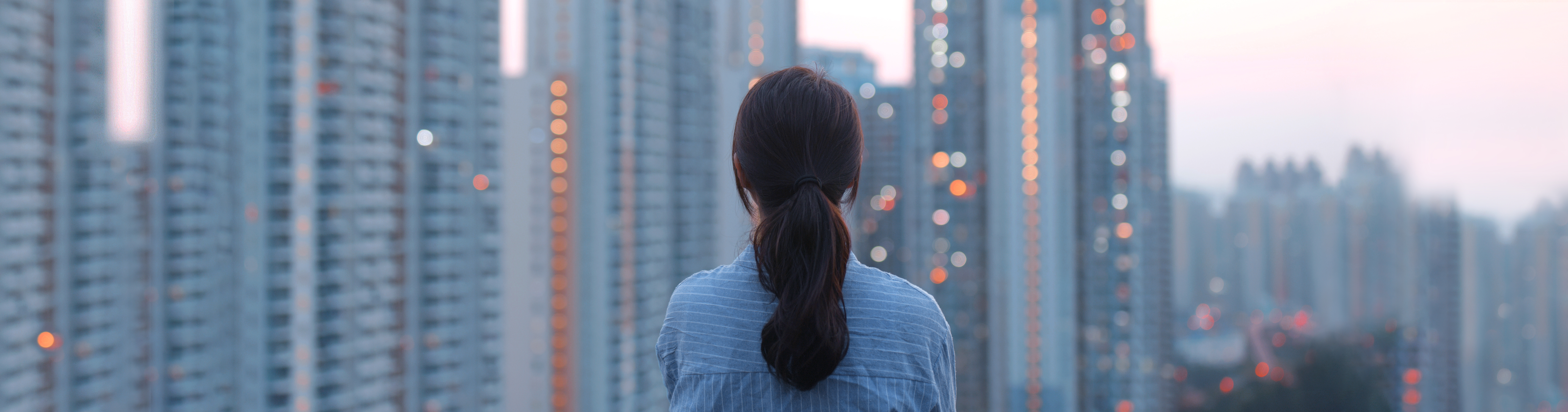 Woman in front of a city looking at the skyline
